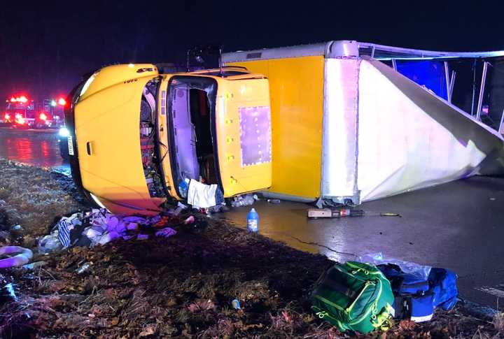 First responders were called to help extricate a truck driver who was trapped inside a rolled over tractor-trailer