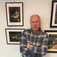 <p>Wayne Ross with a selection of his pictures on display at the River Edge Public Library.</p>