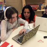 <p>Reebel owner Reena Chawla works with two of her students during a 90-minute technology class.</p>