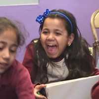 <p>A young girl excited about her new sneakers.</p>