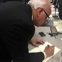 <p>Lyndhurst Mayor Robert Giangeruso signs a shared service agreement that will allow a new junior high school to be built.</p>