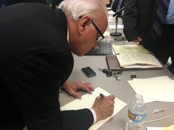 Lyndhurst Mayor Robert Giangeruso signs a shared service agreement that will allow a new junior high school to be built.