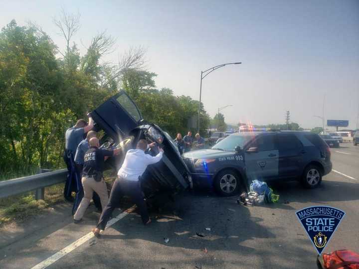 Rescue workers work to free a 29-year-old woman from a crashed car Monday morning, May 22. The Westfield driver was taken to the hospital with non-life-threatening injuries.