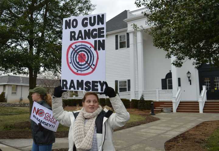 Demonstrators waved their signs at passing motorists in Ramsey.