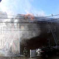 <p>Flames shot through the windows of the Harrison Avenue home in Garfield.</p>