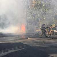 <p>Members of the Goldens Bridge Fire Department demonstrate how they work during an active fire.</p>