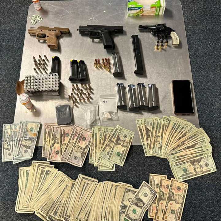 The recovered cash, drugs, and weapons.