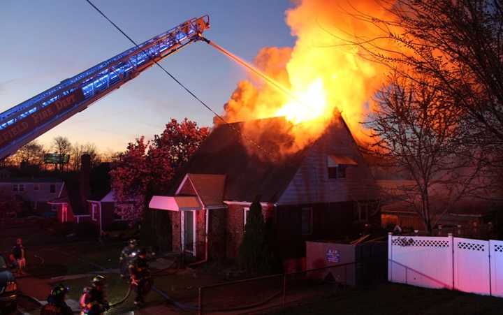 Flames shot through the attic roof.