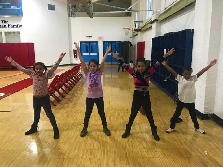 Young members of the Cardinal Shehan Center do jumping jacks as part of the Fitness for Life program supported by the Rotary Club of Bridgeport Foundation.