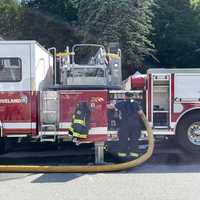 <p>Firefighters at the scene of a three-alarm fire at 2 Manor Drive, Groveland, on Friday afternoon.</p>