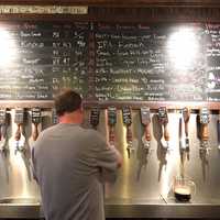 <p>A bartender at Growler &amp; Gill draws some liquid gold from one of the Nanuet gastropub&#x27;s 24 taps.</p>