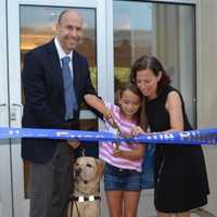 <p>Guiding Eyes for the Blind President and CEO Thomas Panek with Gus the dog, assist in cutting the ribbon for the renovated Canine Development Center&#x27;s new puppy pavilion.</p>