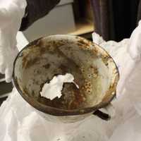 <p>The museum&#x27;s Director of Education Amy SaNogueira holds a bowl from a concentration camp used for daily meals.</p>