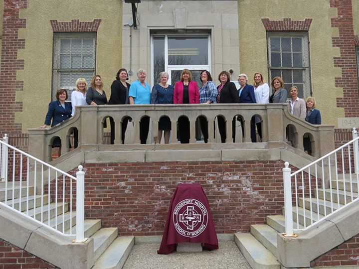 Members of the BHSN faculty, including Director Linda Podolak (center) pose outside the school’s main entrance.