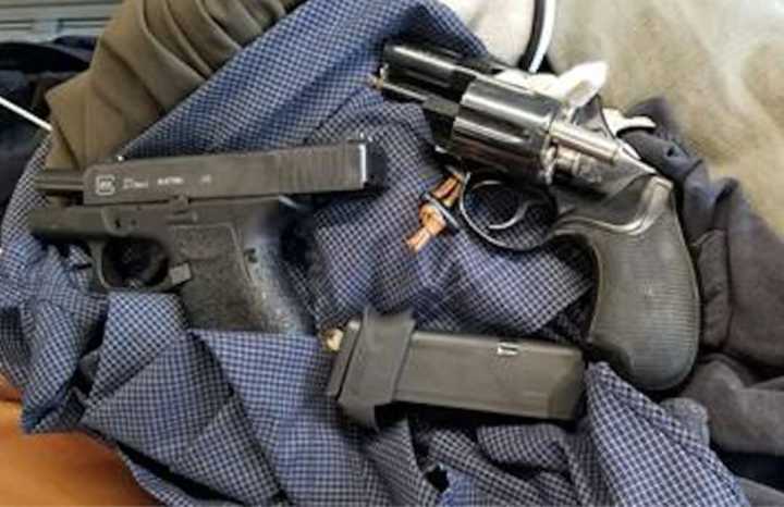 A Kentucky man tried to board a flight in Newark with two loaded guns in his carry-on, authorities said.