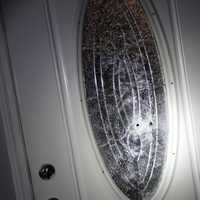 <p>Damage to the home&#x27;s front door during a drive-by shooting.</p>