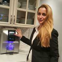 <p>Adi Oren of Fair Lawn with her Aquatal countertop water dispenser.</p>