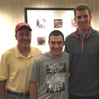 <p>Eli with John and his parents</p>