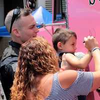 <p>Hillsdale Police Officer Corey Rooney gives youngster a boost.</p>