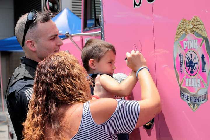 Hillsdale Police Officer Corey Rooney gives youngster a boost.