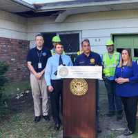 <p>Officials gather in a Long Island community to demolish a zombie home.</p>