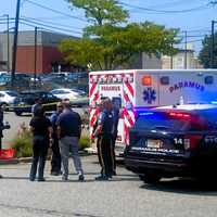 <p>Paramus police and EMS workers in the parking lot of the Shop Rite after a woman was knocked unconscious by an SUV.</p>