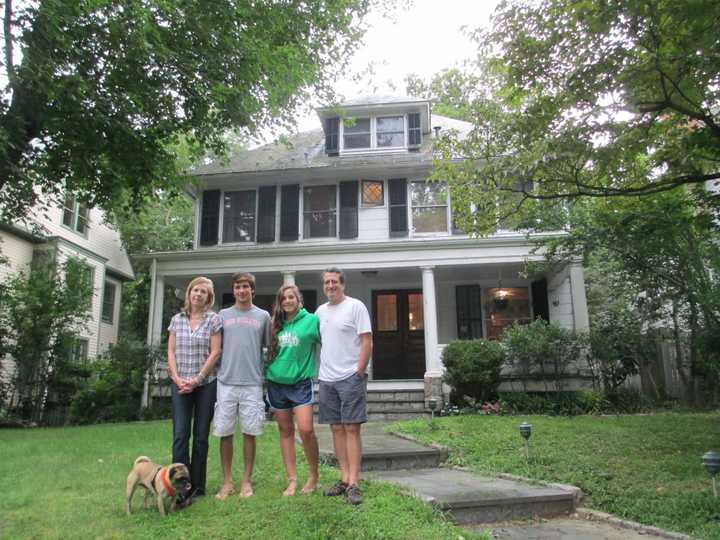 The Chintz family in front of their energy efficient home.