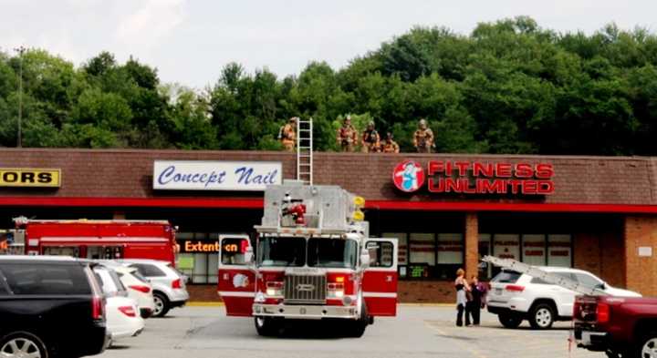 A crew on the roof at the Kmart Shopping Center Saturday afternoon.