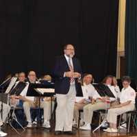 <p>Sal LaRusso, director of the Westport Community Band, speaks to the audience in Westport Town Hall before the band performs for the Veterans Day service.</p>