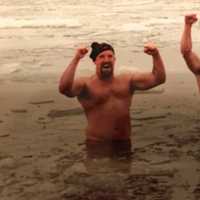 <p>Participants in an annual Super Bowl Sunday fundraising plunge celebrate at Grassy Point.</p>