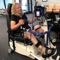 <p>Lois Hamilton cools down from her workout on a specialized bike at Push to Walk in Oakland.</p>