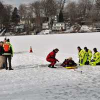 <p>The diver is taken from the water and moved to a rescue sled for quick transport to the shore</p>