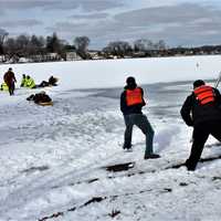 <p>Tenders haul the diver to shore</p>