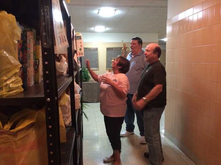 Volunteers Jackie Catti, Tom Mulcahy and Al Catti at the Our Lady of Perpetual Help Church pantry.
