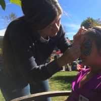 <p>Laura Taveras paints a butterfly pattern on the face of Brianna Petrella, 9, of Wyckoff.</p>