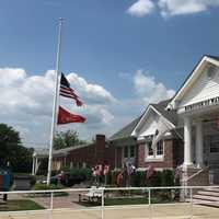 <p>Flags are at half staff in front of the Police Officer Christopher Goodell Public Safety Building in Waldwick.</p>