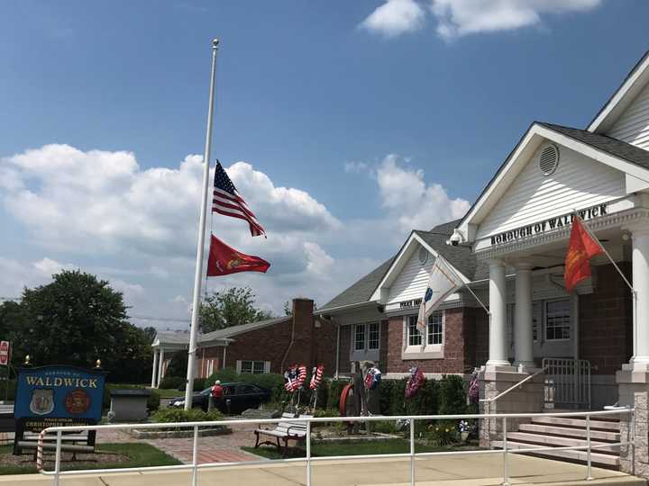 Flags are at half staff in front of the Police Officer Christopher Goodell Public Safety Building in Waldwick.