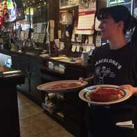 <p>Server Stephanie Corona at Barcelona&#x27;s Restaurant in Garfield. The restaurant serves a host of Italian fare, along with pizza.</p>