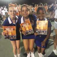 <p>From left to right, Kiera McCarthy, Emily Bustelo and Ella Brown, all of Danbury and members of the Junior Hatters Cheerleaders, show where they’re taking part in the Thanksgiving Day parade.</p>