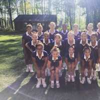 <p>Danbury Junior Hatter cheerleaders pause for a group photo during their time at Universal Cheerleaders Association camp in Pine Forest, Pa., in August, 2016.</p>