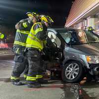 <p>Ridgewood firefighters extricate the minivan passenger.</p>