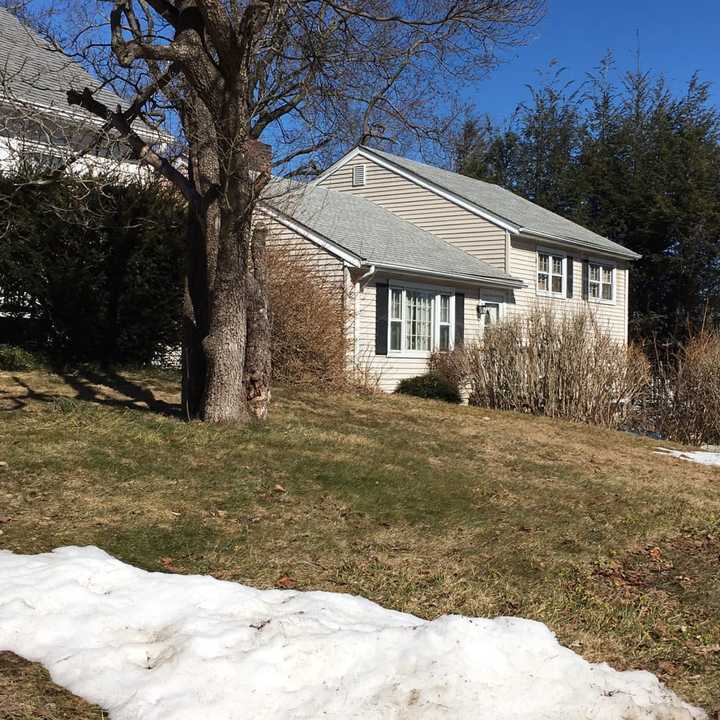 A patch of snow remains under bright skies in Danbury on Monday.