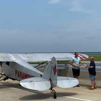 <p>Landon Lucas (in blue) landed his banner plane in Ocean City Monday afternoon.</p>