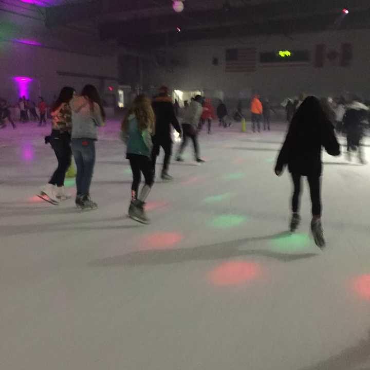 Skaters glide around the rink.