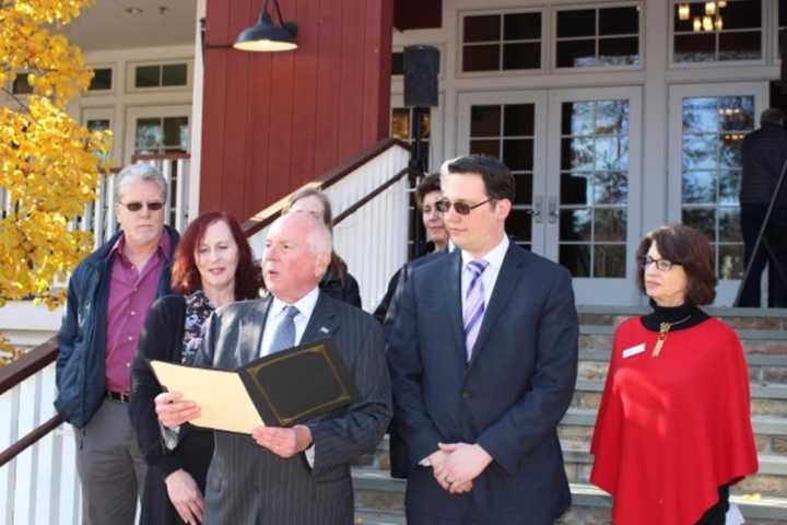 Westport First Selectman James Marpe reads a proclamation designating Nov. 29, 2016 as Giving Tuesday in Westport. Standing on the steps of the Westport Country Playhouse, he is surrounded by representatives of local nonprofits.