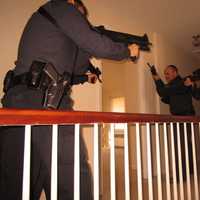 <p>Ridgewood Officers Anthony Mormino and Joseph DiBenedetto and Sgt.Jay Chuck prepare to enter a room during a SWAT training exercise.</p>