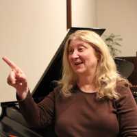 <p>Marlane Tubridy gestures to members of Cantiamo choir. She will direct the choir in a Christmas concert at Westport Town Hall Friday, Dec. 9, 2016.</p>