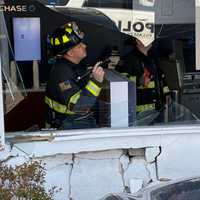 <p>Village firefighter surveys damage at the Chase Bank branch on Godwin Avenue in Ridgewood.</p>