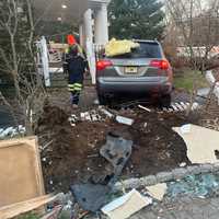 <p>The Acura knocked down a fence and finally came to a stop next to the porch of the house on Van Dien Avenue in Ridgewood.</p>