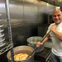 <p>Carlo Filippone mixes vegetables at Elite Lifestyle Cuisine in Fairview.</p>